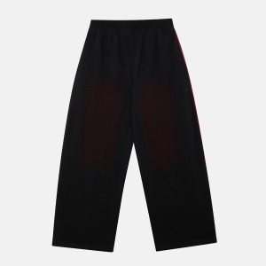 Pantalones Savage lavados, negros y rojos.